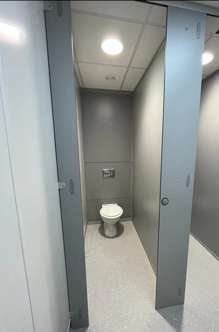 Open public restroom cubicle with toilet.