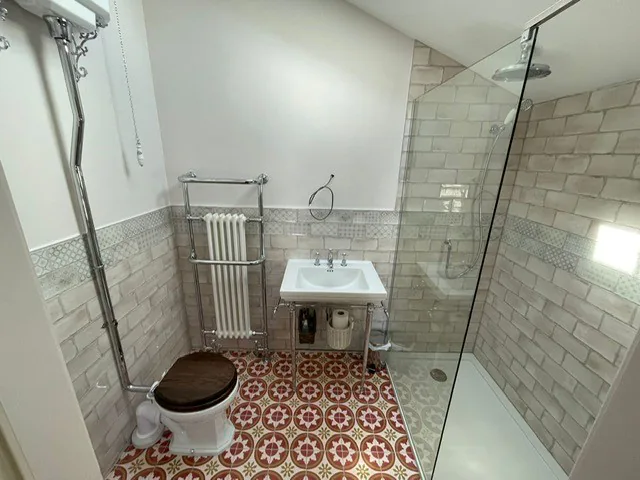 Stylish bathroom with vintage tiles and modern shower.