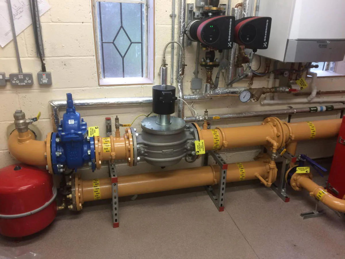 Industrial piping system with labelled valves and gauges.