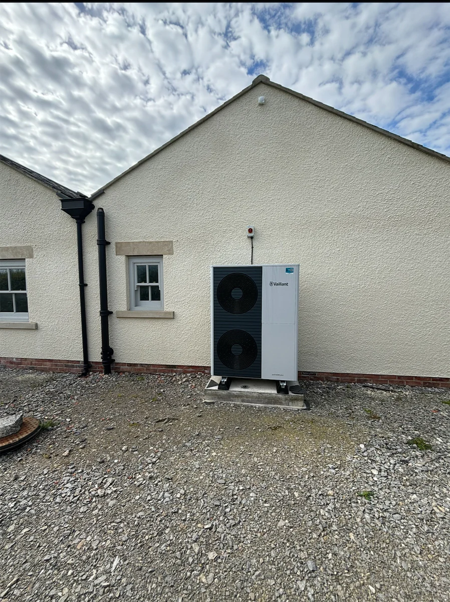 Air source heat pump outside white house