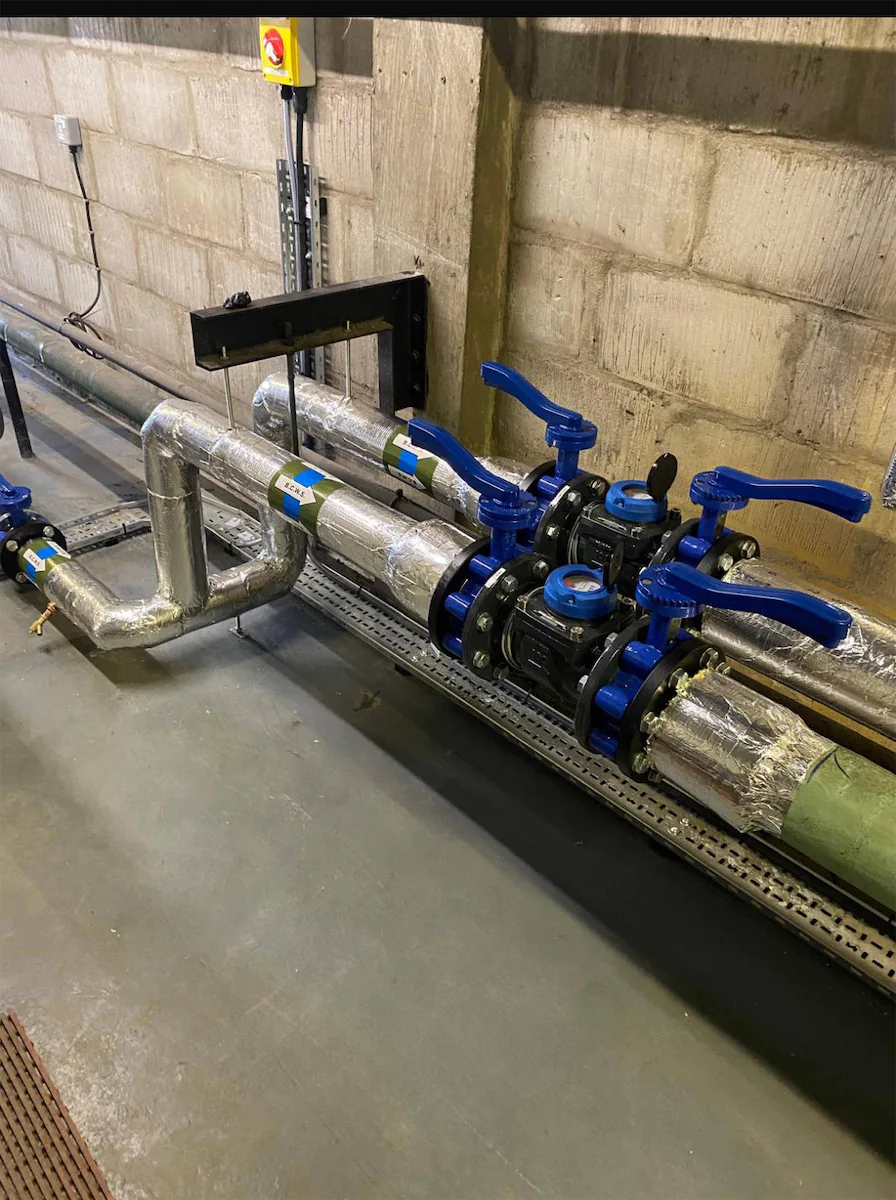 Industrial pipes with blue valves in a facility