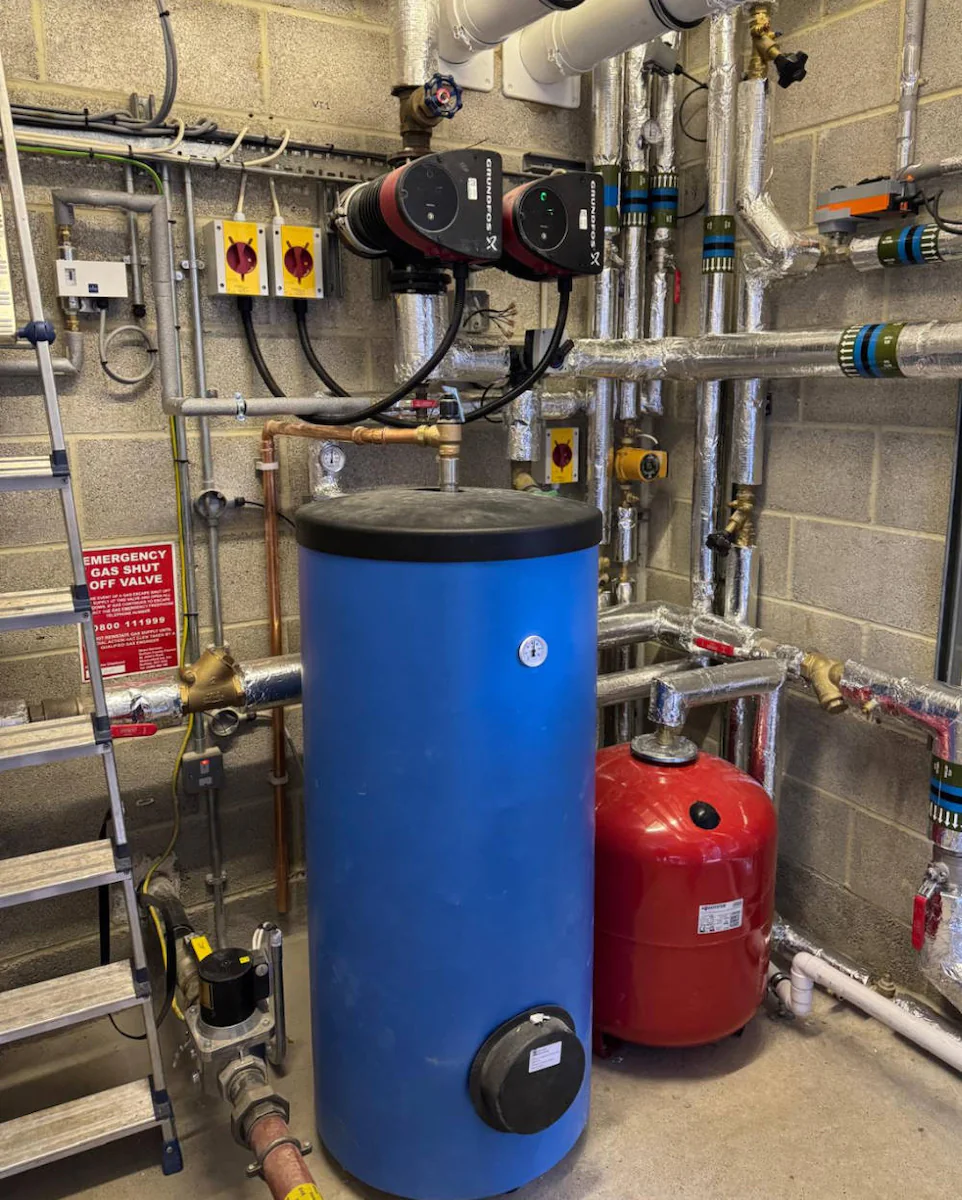 Industrial boiler room with pipes and equipment.