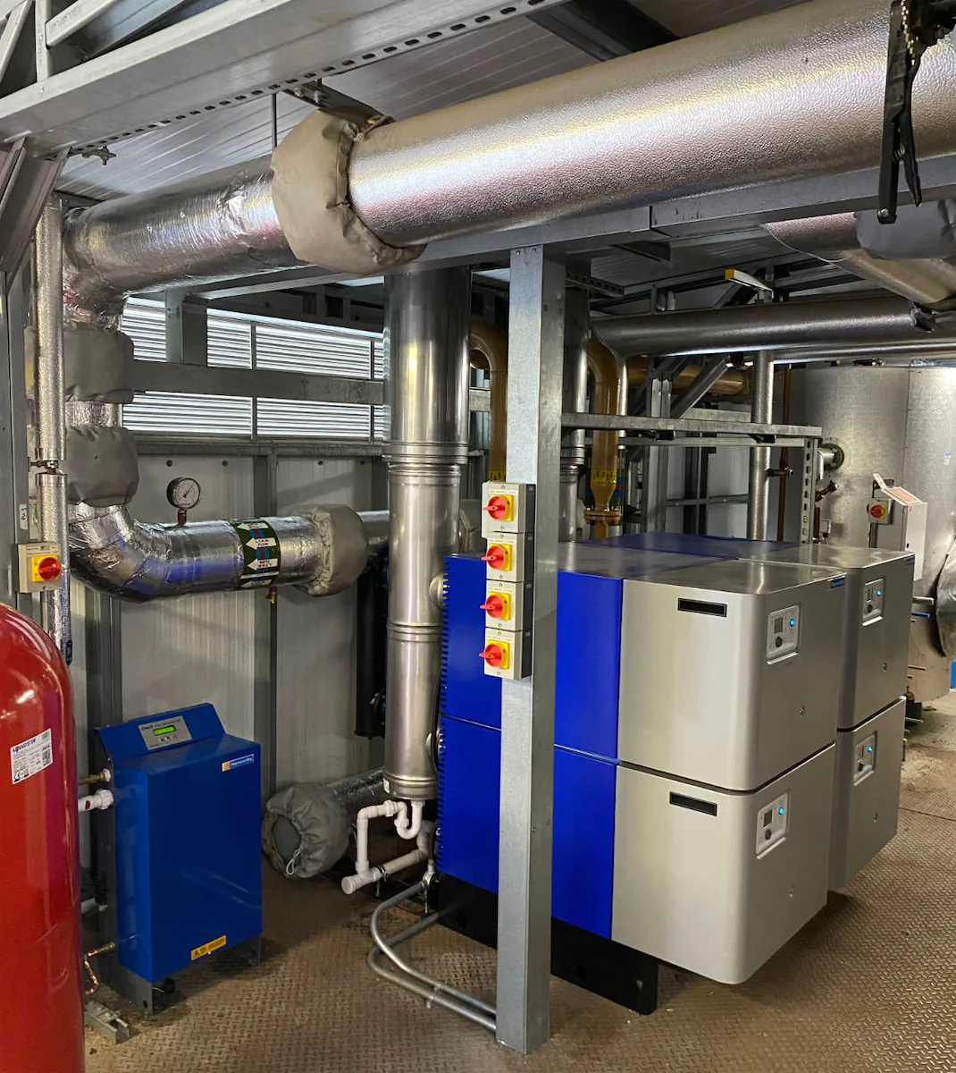 Industrial boiler room with metal pipes.