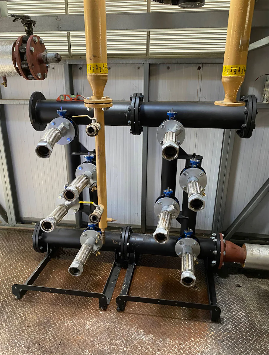 Industrial pipe system with multiple valves and fittings.